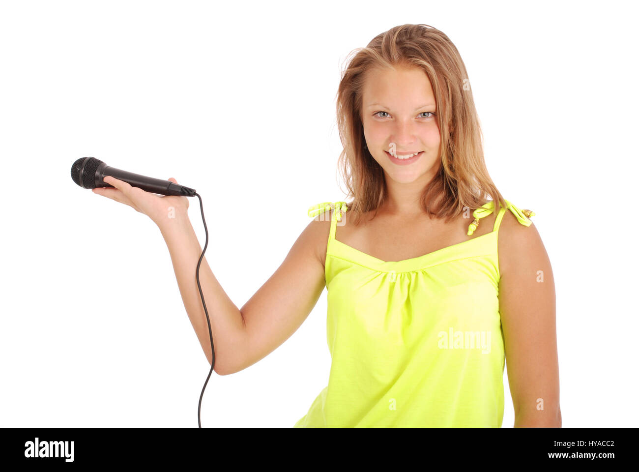 Happy young beautiful girl singing with microphone isolated on white