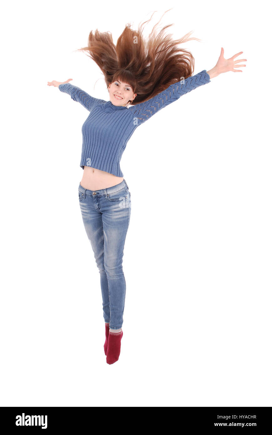 Full length portrait of a cheerful girl jumping isolated on a white ...