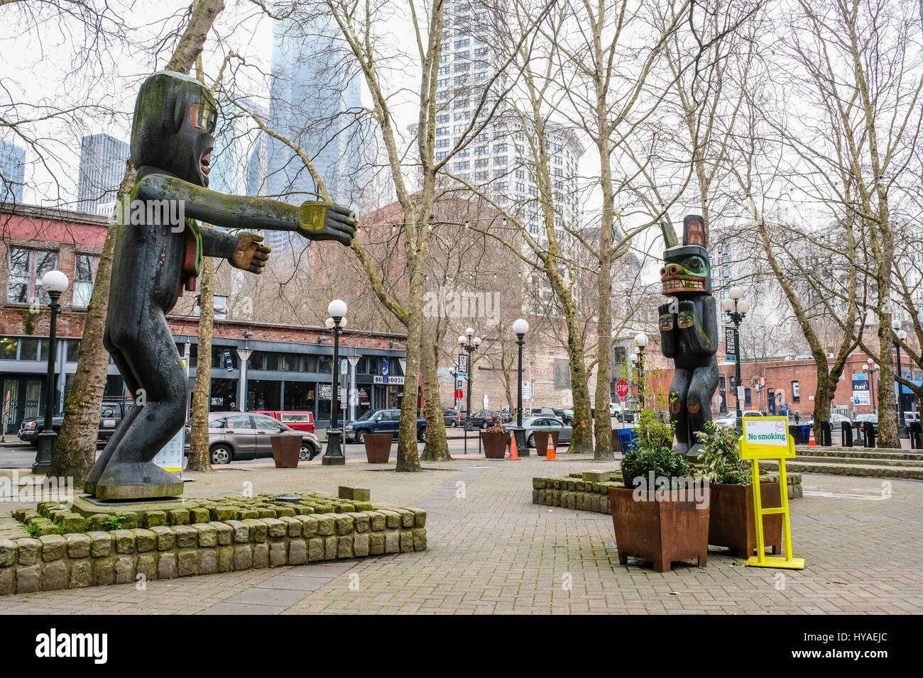 Two Northwest native American totem poles in Seattle's Pioneer Square.  No people around. Horizontal image. Stock Photo