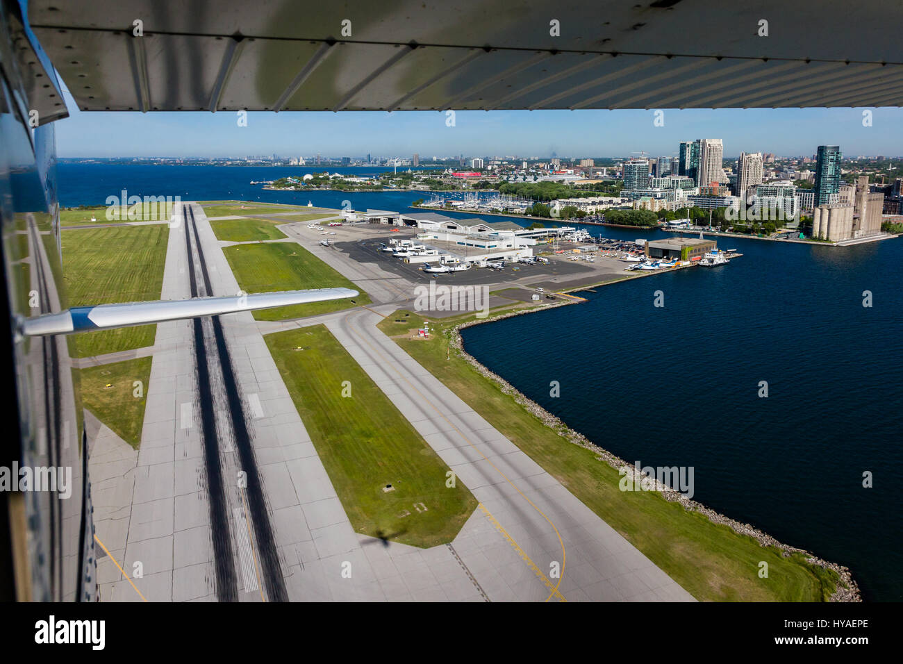 A view from a small plane looking back at the runway and airport terminal at Billy Bishop Airport in Toronto. Stock Photo