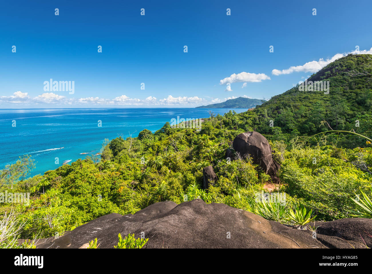 View from Anse Major Nature Trail over the northwest coastline of Mahe island and granite rock in the foreground Stock Photo