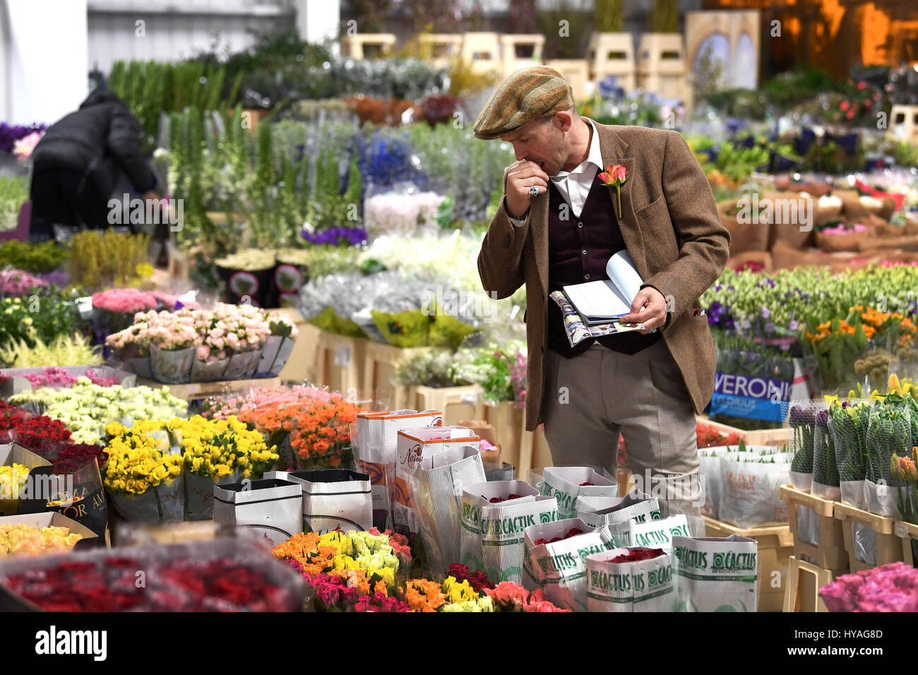 EDITORIAL USE ONLY Flower trader, Eddie Martin, prepares blooms at the Flower Market at New Covent Garden Market for the first time today at the opening of the new Nine Elms Lane site, London. Stock Photo