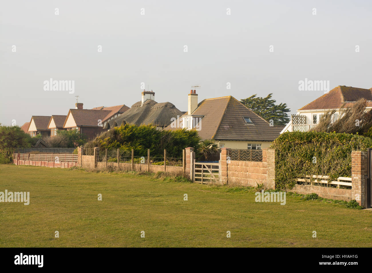 large houses and mansions behind brick walls. fences and hedges on the