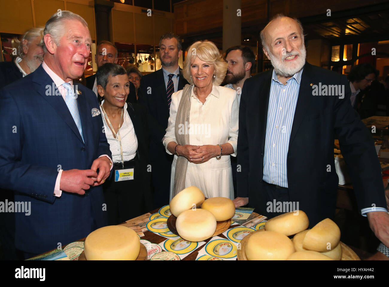 The Prince of Wales and the Duchess of Cornwall with the founder Carlo Petrini (right) as they visit Sant'Ambrogio Market to celebrate the Slow Food movement and meet local food producers of the Abruzzo region and areas affected by the Italian earthquakes of 2016, on the sixth day of his nine-day European tour. Stock Photo