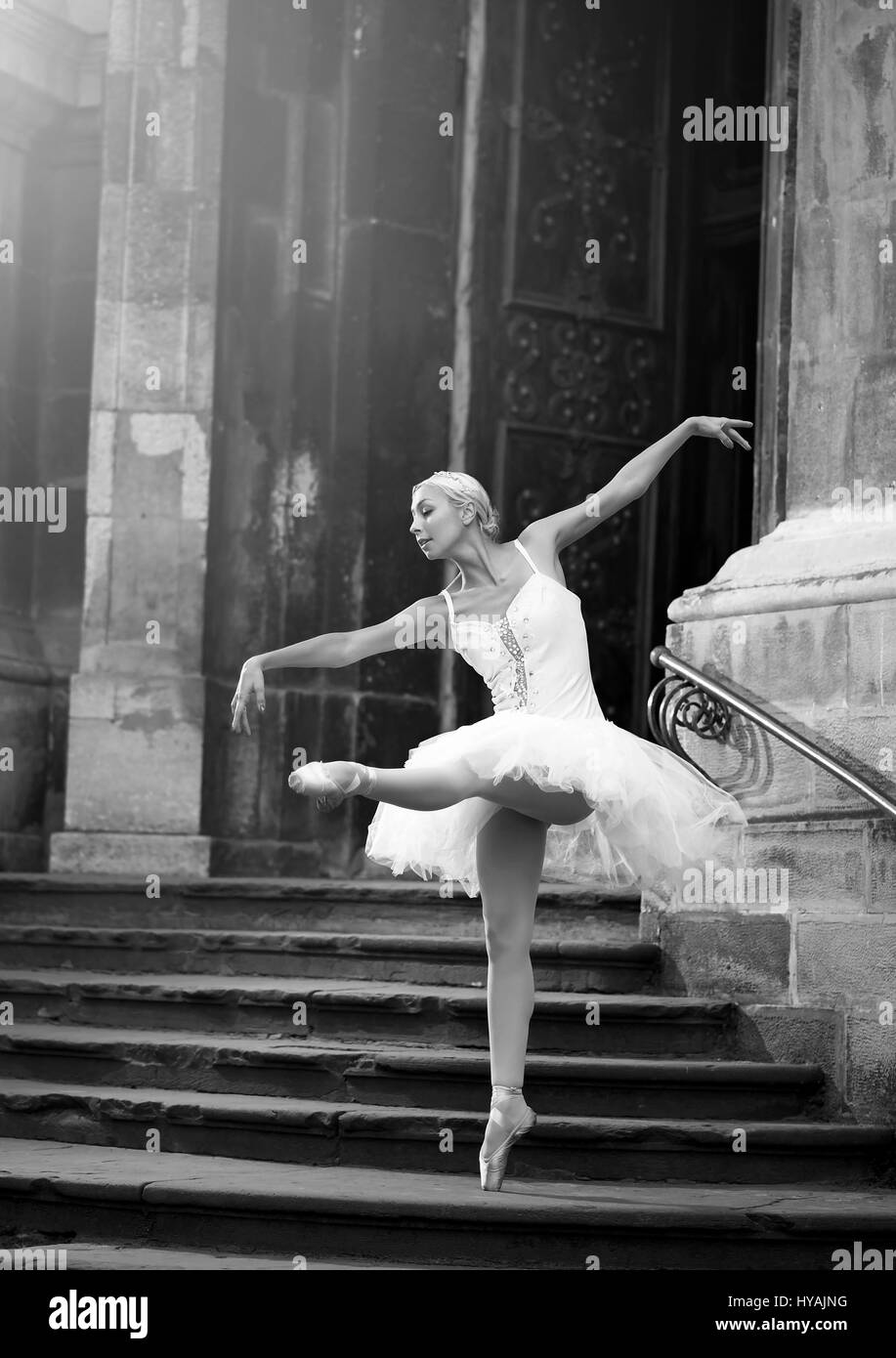 Young ballerina woman posing on stairs Stock Photo