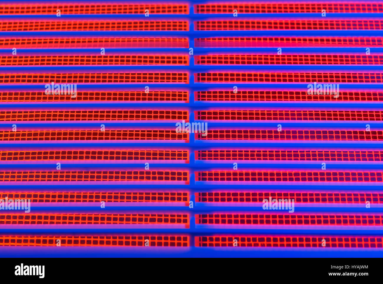 Abstract image of a part of the ventilation grill with a blue and red illumination. Stock Photo