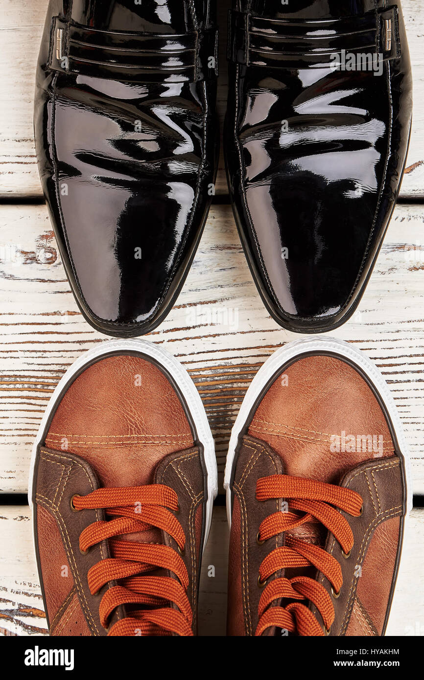 Patent-leather shoes and gumshoes. Stock Photo