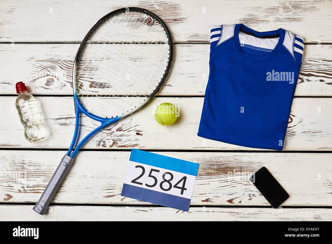 Racket, phone and T-shirt. Stock Photo