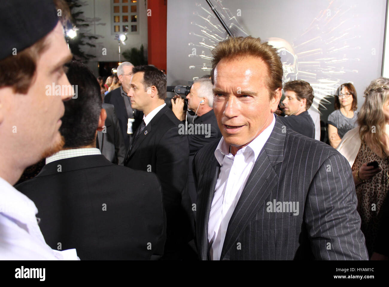 SACREMENTO, CALIFORNIA: Schwarzeneggar superfan Randy Jennings interviewing Arnie for Expendibles 2, 2012. THE WORLD’S number one Arnie superfan is celebrating his muscle-bound hero’s 67th birthday by revealing his Schwarzenegger shrine for the first time. From the carefully tending to his USD80K (£45K) collection of Arnold Schwarzenegger memorabilia to spending hours managing 90,000 new followers per month at his Arnie’s Army fansite – one superfan has made it his life’s mission to the Total Recall of his all-time idol. Since he was just eleven-years old and watched the legendary Arnie movie, Stock Photo