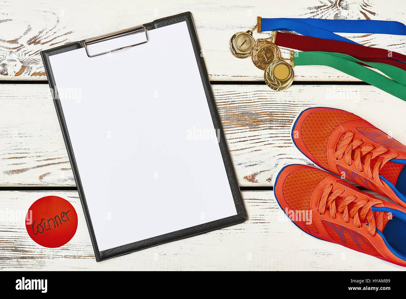 Medal, sneakers and clipboard. Stock Photo
