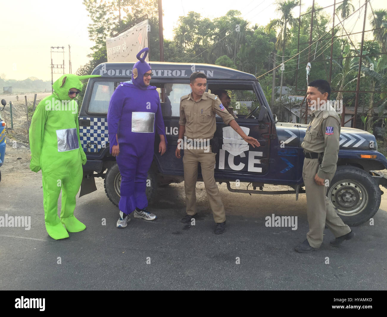 Indian police inspect 'Delhitubbies' Tyler Newman (left) and Phillip Miller (right). THREE BRITONS are saying E-OH to the Subcontinent by taking on the eccentric challenge of crossing India on a rickshaw dressed as the iconic children’s television characters the Teletubbies. Driving 2,000miles on pothole infested dirt roads from the “Golden City” of Jaisalmer in the state of Rajastan to the station of Shillong in the Himalayas pictures show how locals responded to the wacky-costumed trio who hope to raise £30K for a women’s refuge in Bangladesh. Led by estate agent Sean Newman (47) and joined  Stock Photo