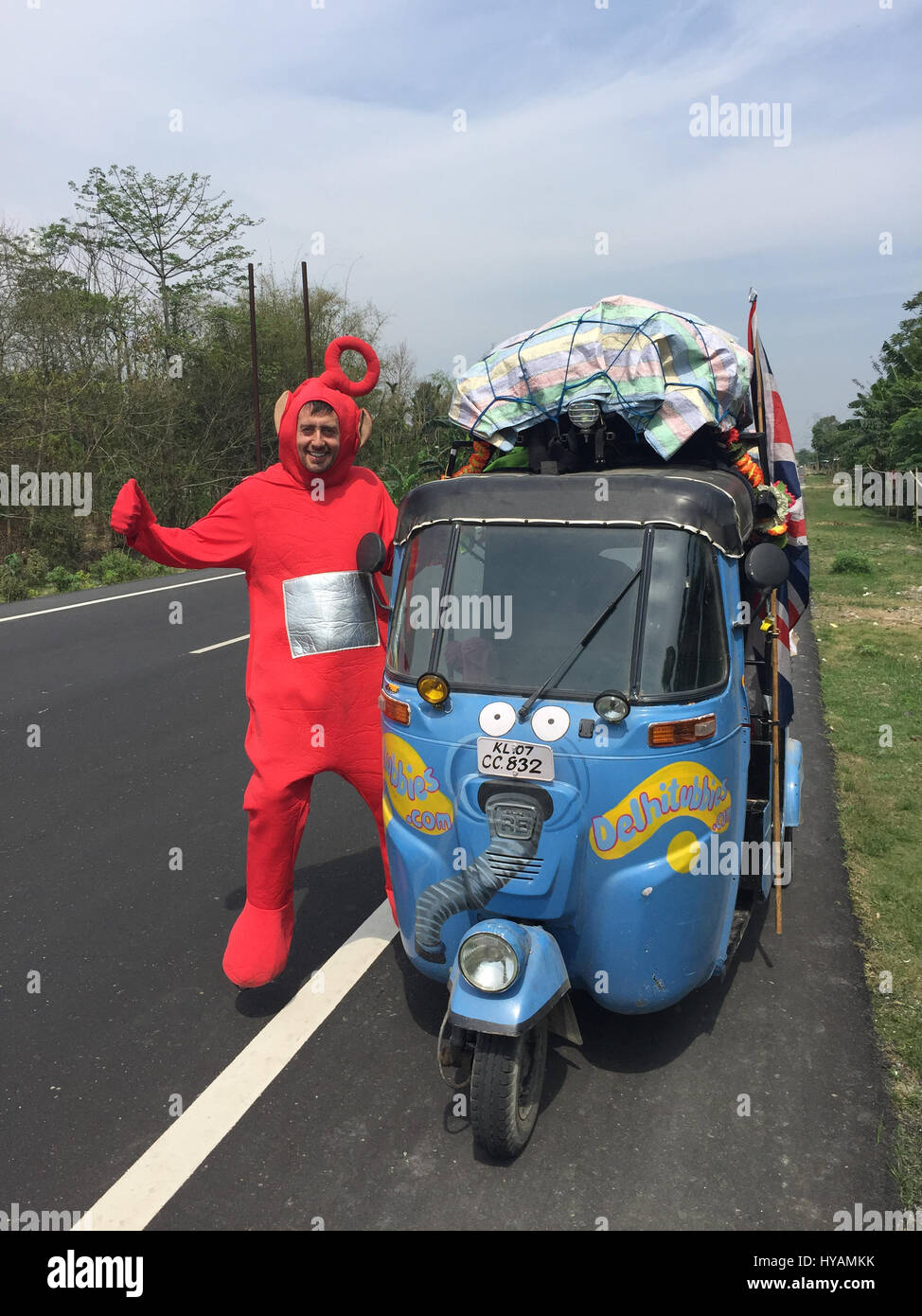 Sean Newman stands next to his autorickshaw Noo Noo. THREE BRITONS are saying E-OH to the Subcontinent by taking on the eccentric challenge of crossing India on a rickshaw dressed as the iconic children’s television characters the Teletubbies. Driving 2,000miles on pothole infested dirt roads from the “Golden City” of Jaisalmer in the state of Rajastan to the station of Shillong in the Himalayas pictures show how locals responded to the wacky-costumed trio who hope to raise £30K for a women’s refuge in Bangladesh. Led by estate agent Sean Newman (47) and joined by his student son, Tyler (18) a Stock Photo