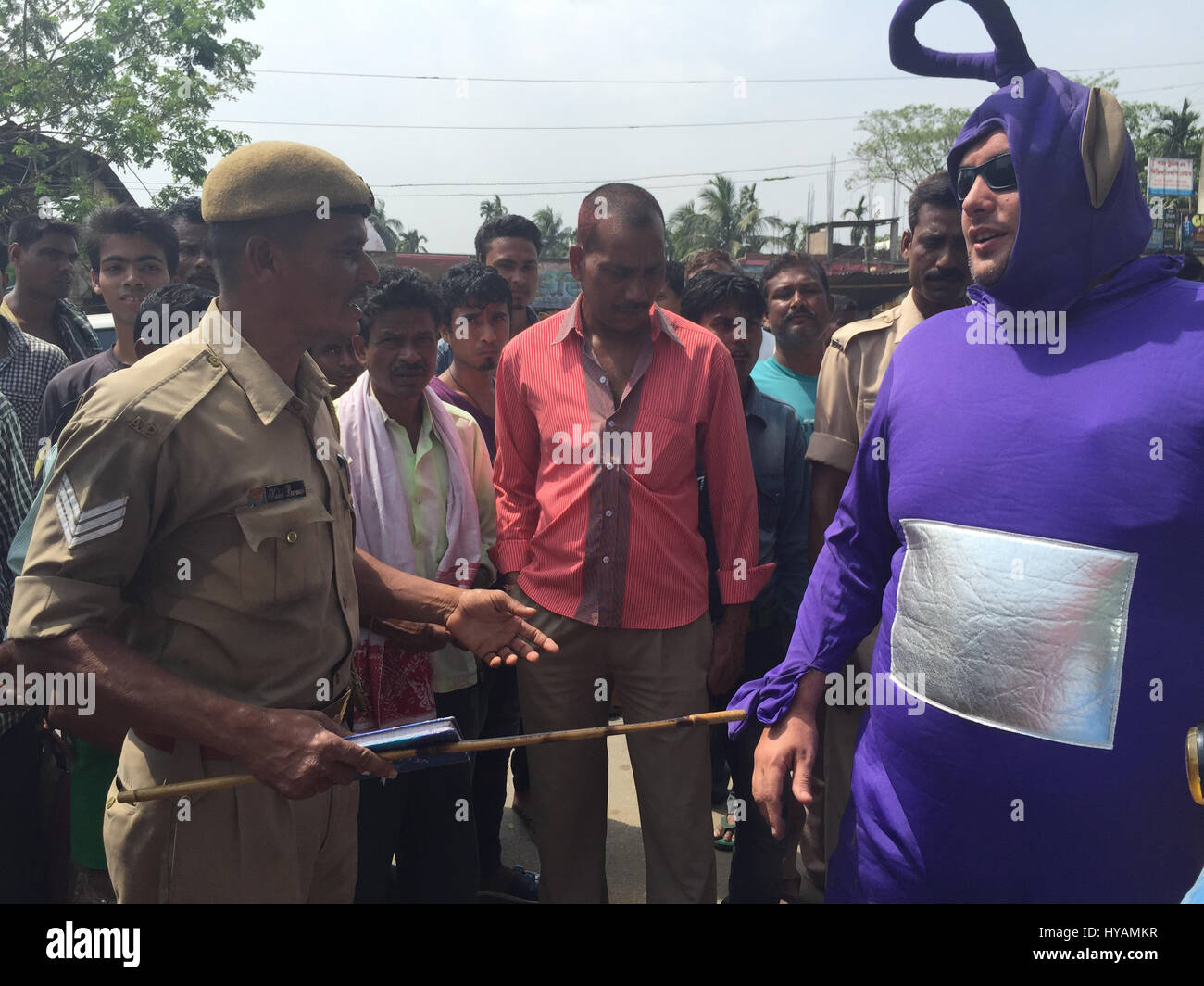 Phillip Miller speaks to a policeman. THREE BRITONS are saying E-OH to the Subcontinent by taking on the eccentric challenge of crossing India on a rickshaw dressed as the iconic children’s television characters the Teletubbies. Driving 2,000miles on pothole infested dirt roads from the “Golden City” of Jaisalmer in the state of Rajastan to the station of Shillong in the Himalayas pictures show how locals responded to the wacky-costumed trio who hope to raise £30K for a women’s refuge in Bangladesh. Led by estate agent Sean Newman (47) and joined by his student son, Tyler (18) and mortgage adv Stock Photo