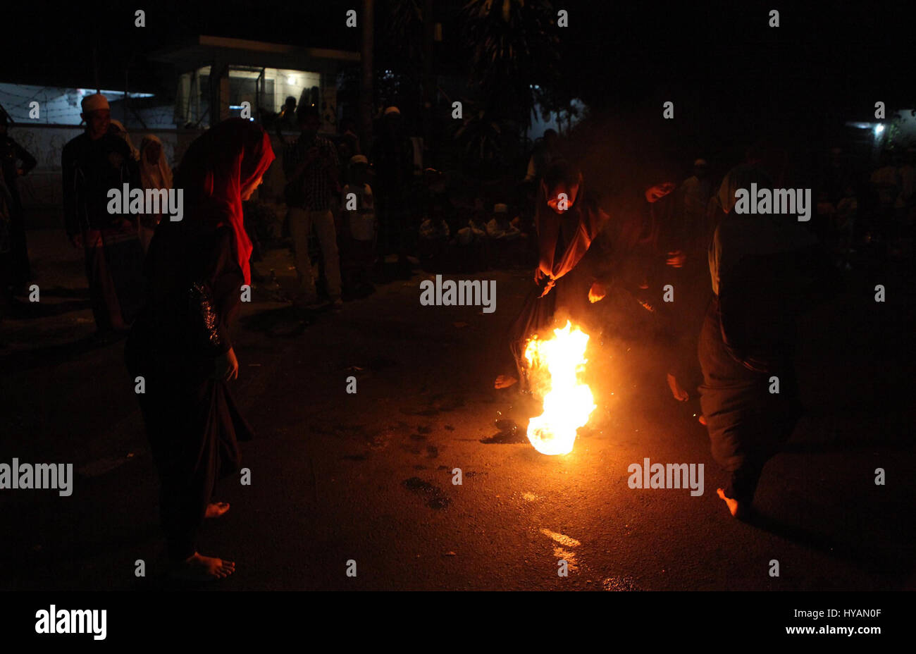 Indonesian muslim women playing a fire football on the street during ...