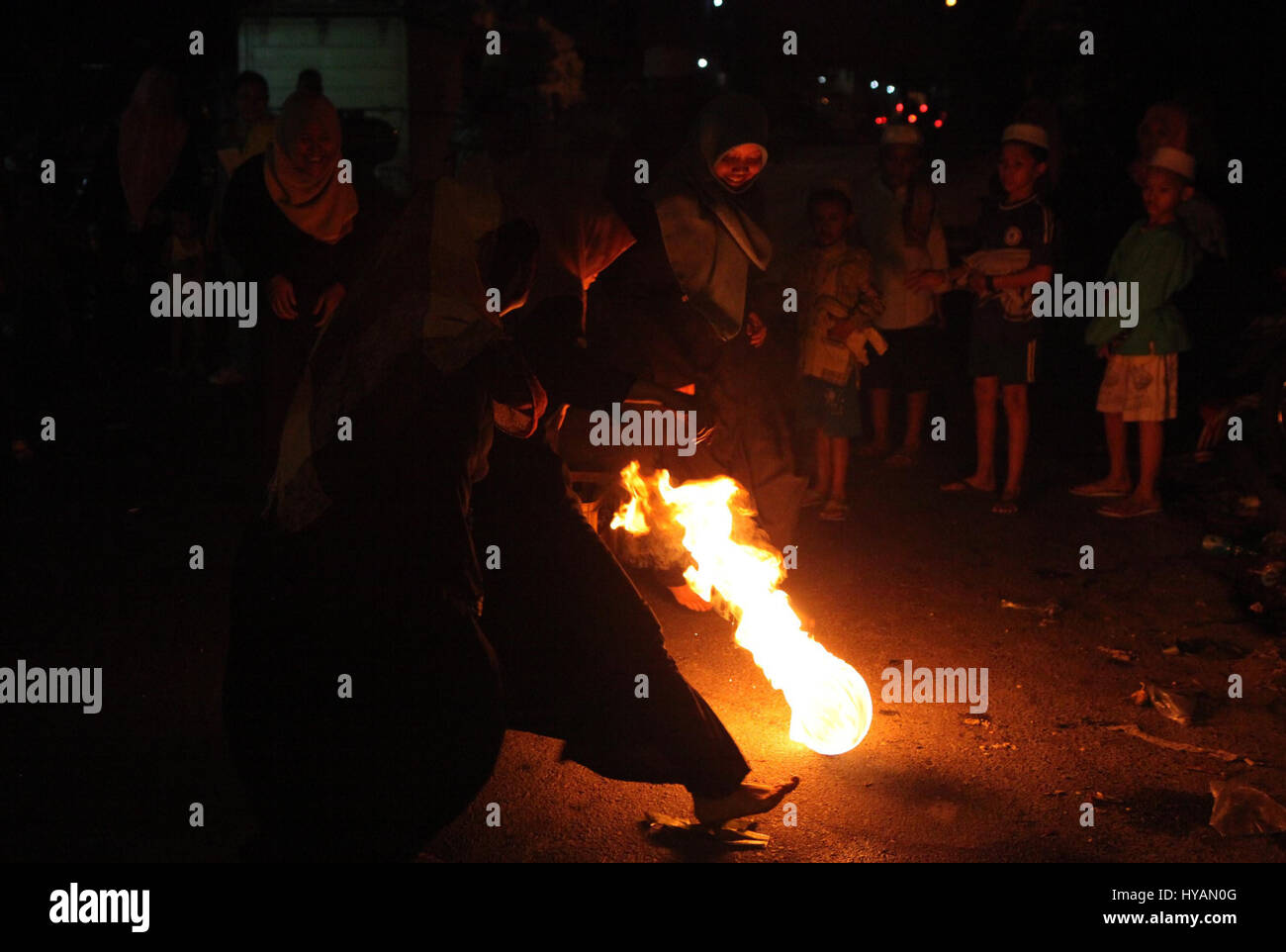 Indonesian muslim women playing a fire football on the street during ...