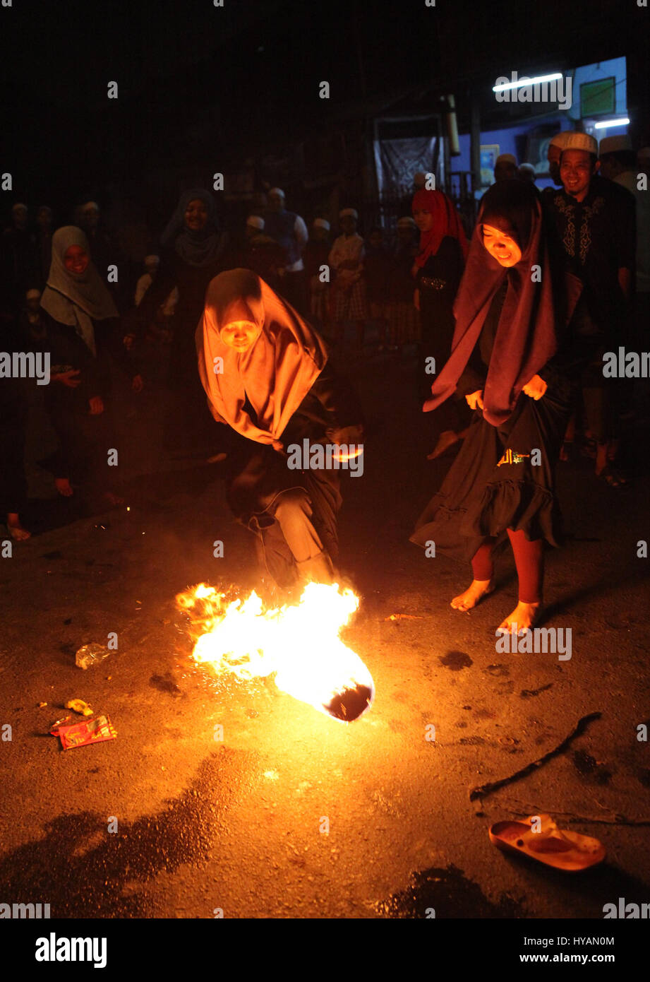 Indonesian muslim women playing a fire football on the street during ...