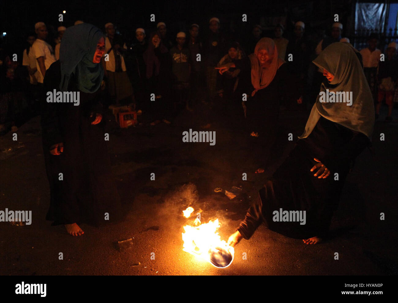 Indonesian muslim women playing a fire football on the street during ...