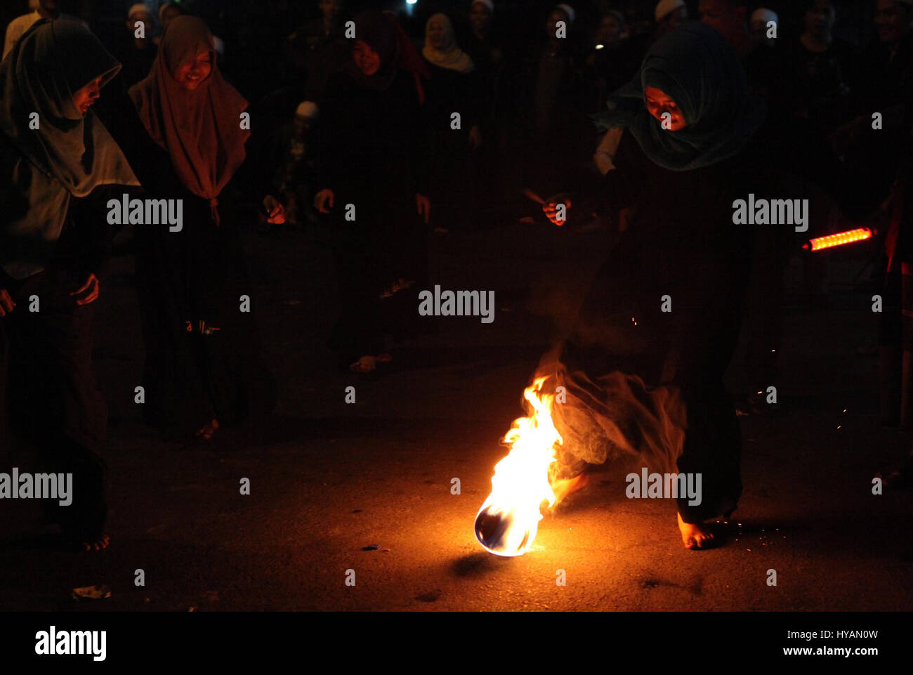 Indonesian muslim women playing a fire football on the street during ...