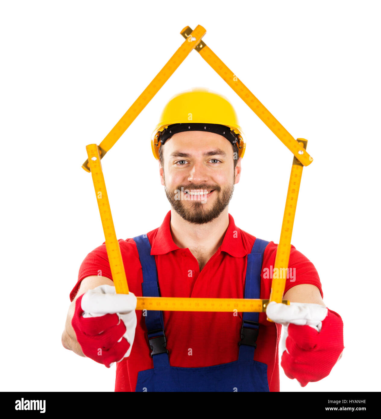 new house and improvement concept - construction worker with wooden ruler in hands Stock Photo