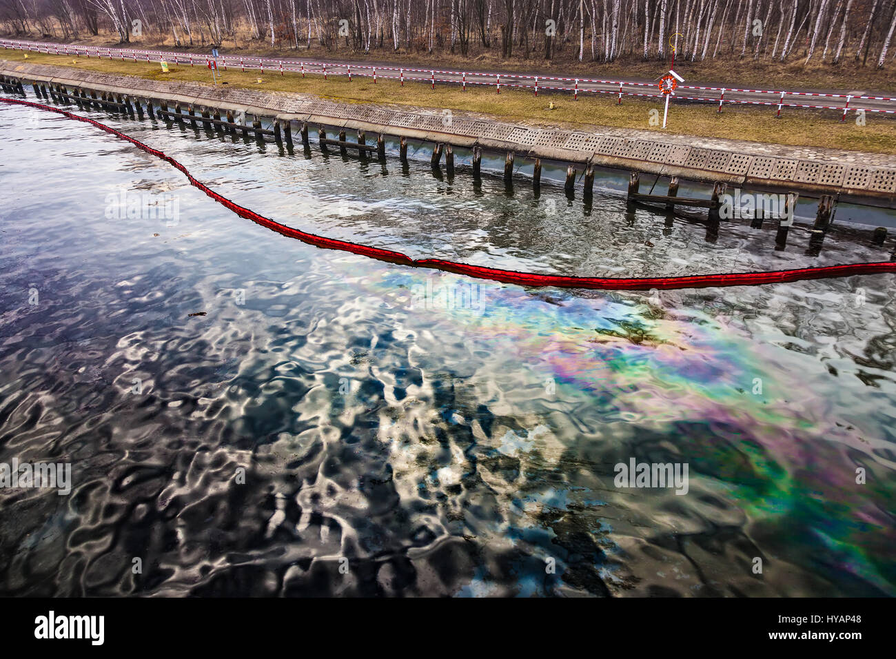 Floating oil boom with oil spill on the water environment pollution
