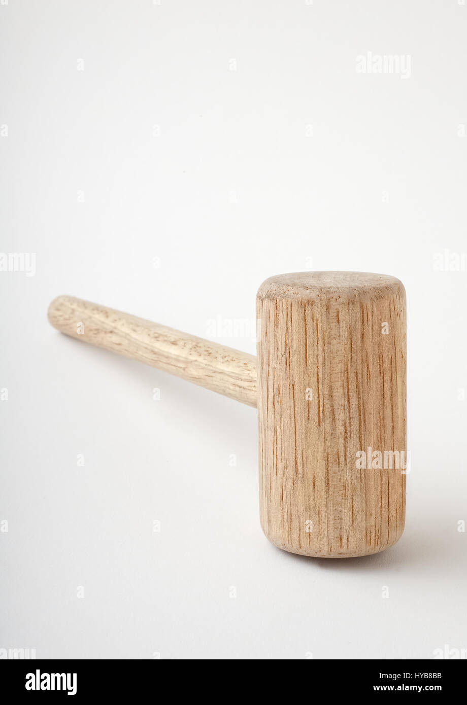 Wooden kitchen mallet lying on side, isolated white background Stock