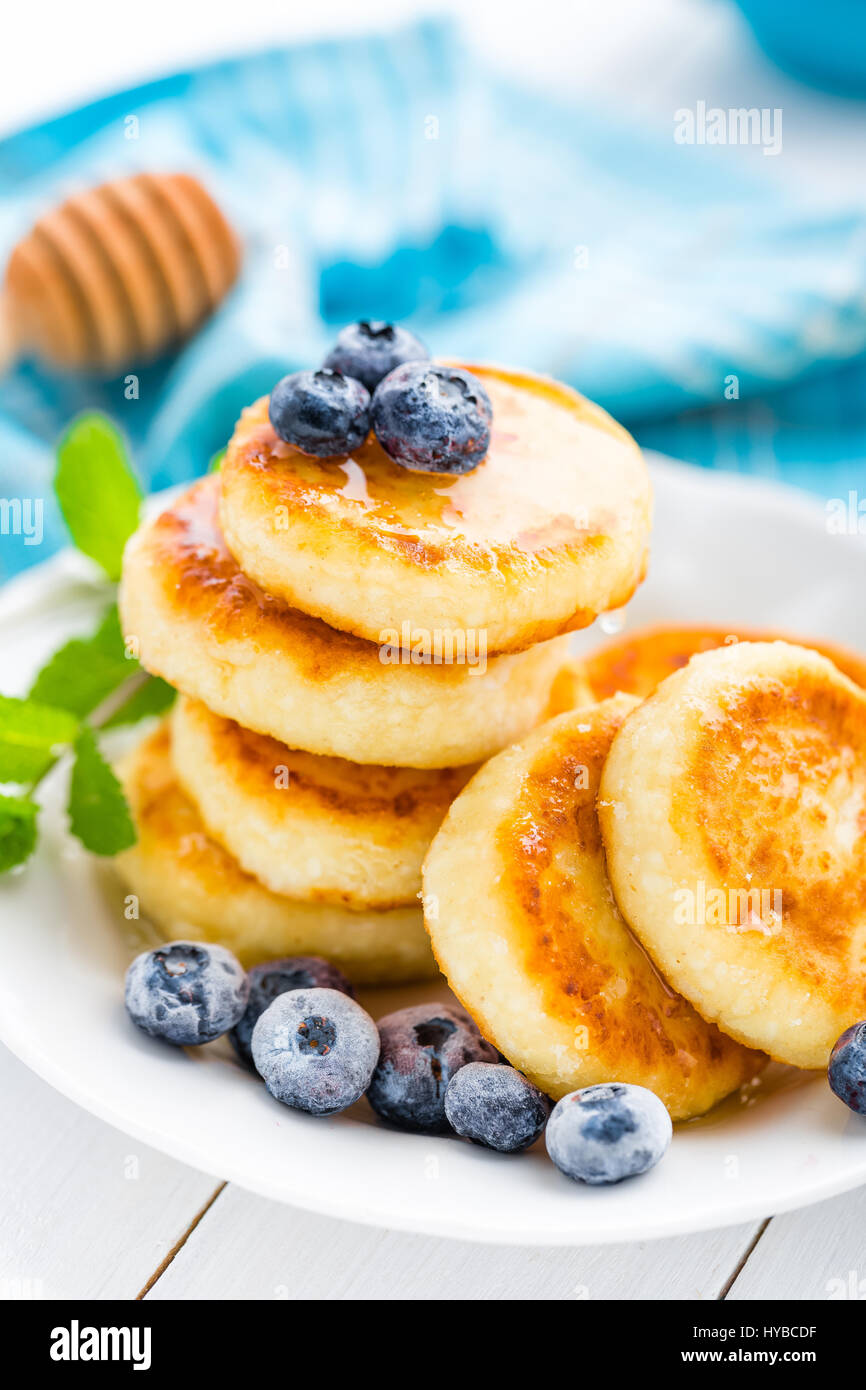 Cottage Cheese Pancakes With Honey And Blueberry On White