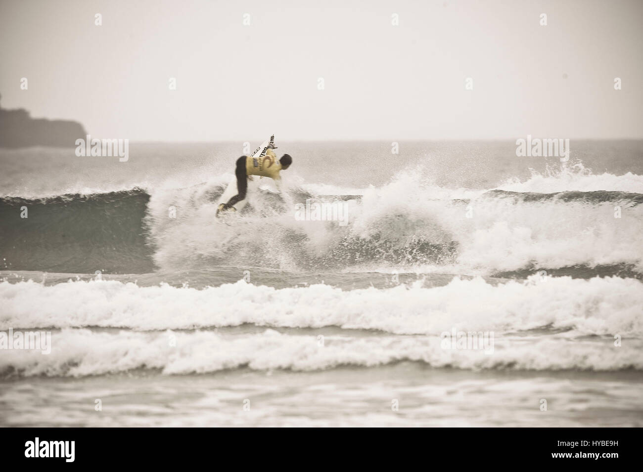 Surfer hand down into wave with multiple wave rolling in Stock Photo