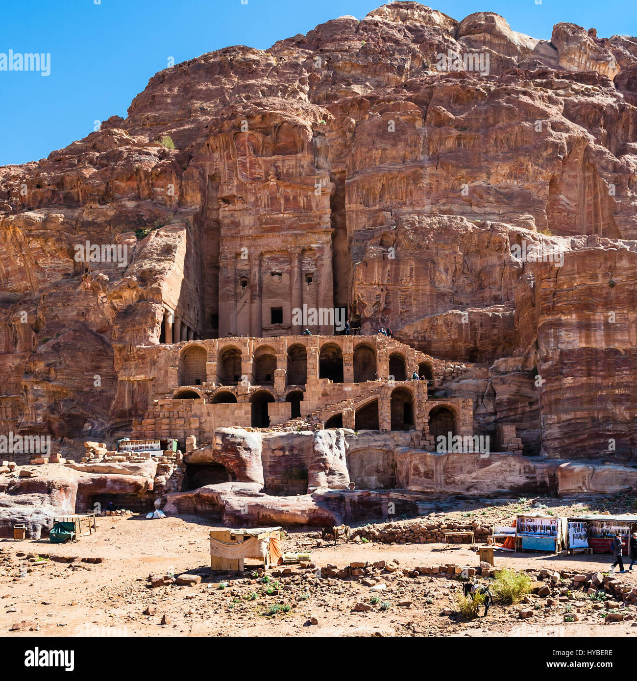 PETRA, JORDAN - FEBRUARY 21, 2012: bedouin camp and Royal Urn Tomb in ancient Petra town. Rock-cut town Petra was established about 312 BC as the capi Stock Photo