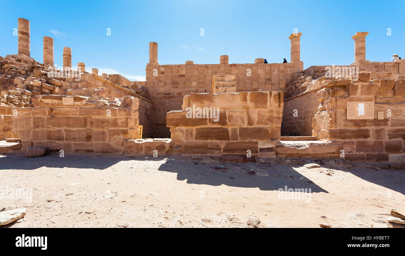 PETRA, JORDAN - FEBRUARY 21, 2012: tourists on Ruins of Great Temple ancient Petra town. Rock-cut town Petra was established about 312 BC as the capit Stock Photo