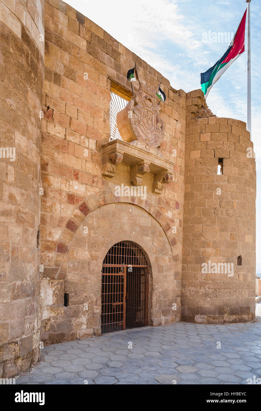 AQABA, JORDAN - FEBRUARY 23, 2012: entrace to Aqaba Fortress (Aqaba Castle, Mamluk Castle, Fort) and Flag of the Arab Revolt. The port of Aqaba was ma Stock Photo