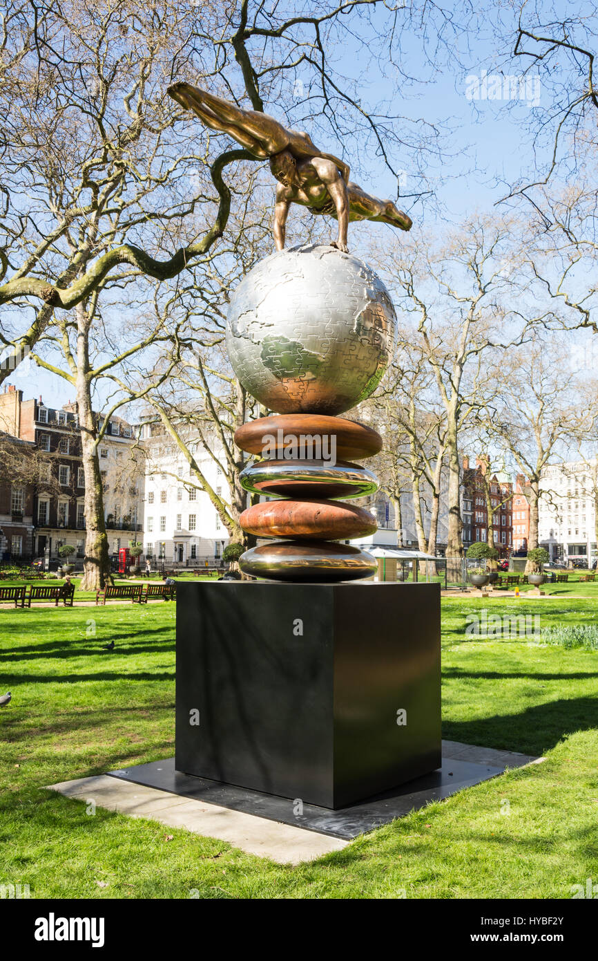 A sculpture in Berkeley Square Gardens showing perfect balance and equilibrium between a man and a woman Stock Photo