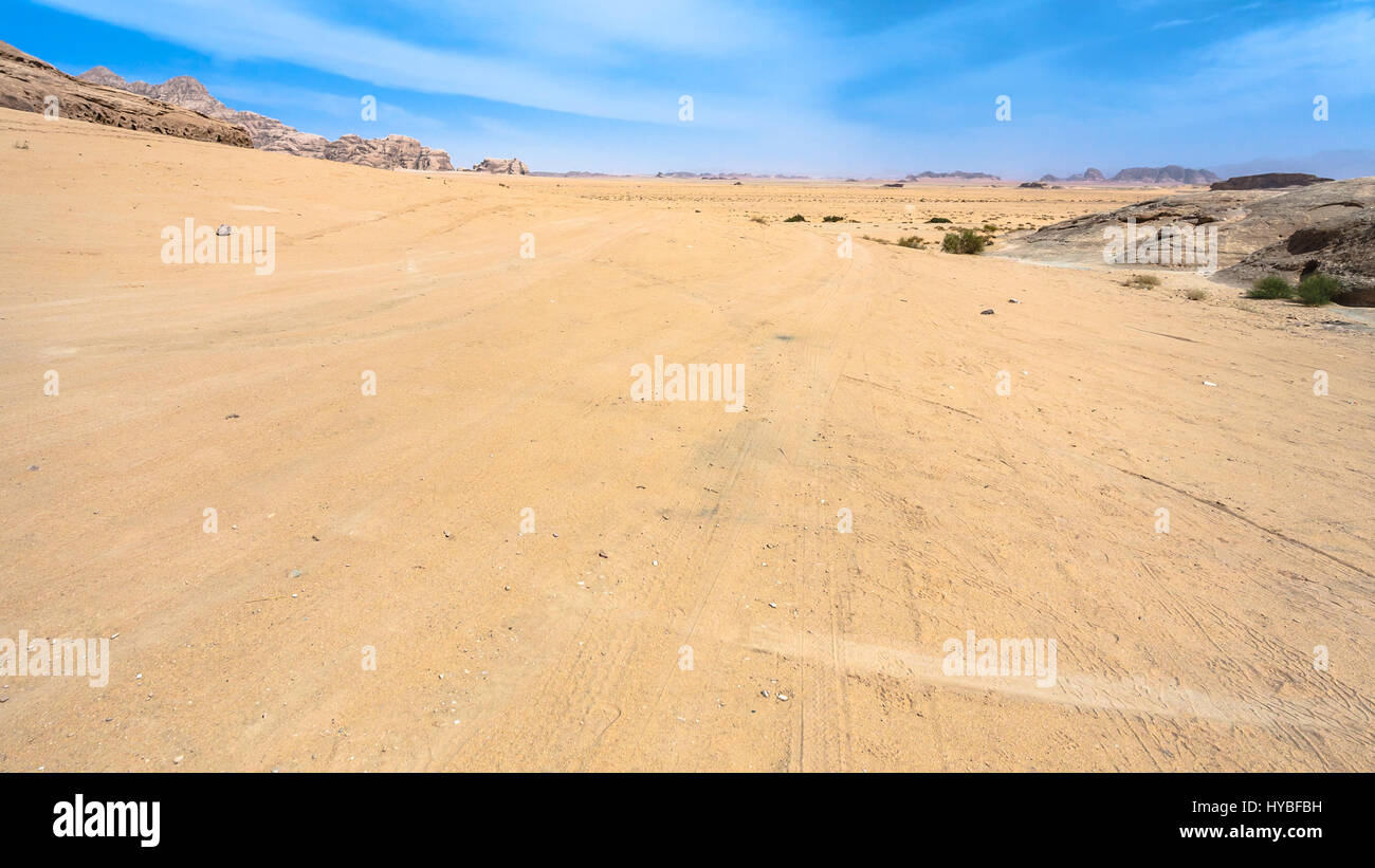 Travel to Middle East country Kingdom of Jordan - road in Wadi Rum desert in sunny winter day Stock Photo