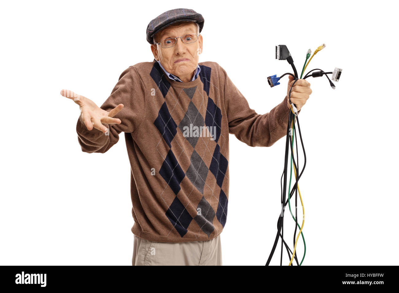 Baffled senior holding different types of electronic cables and looking at the camera isolated on white background Stock Photo