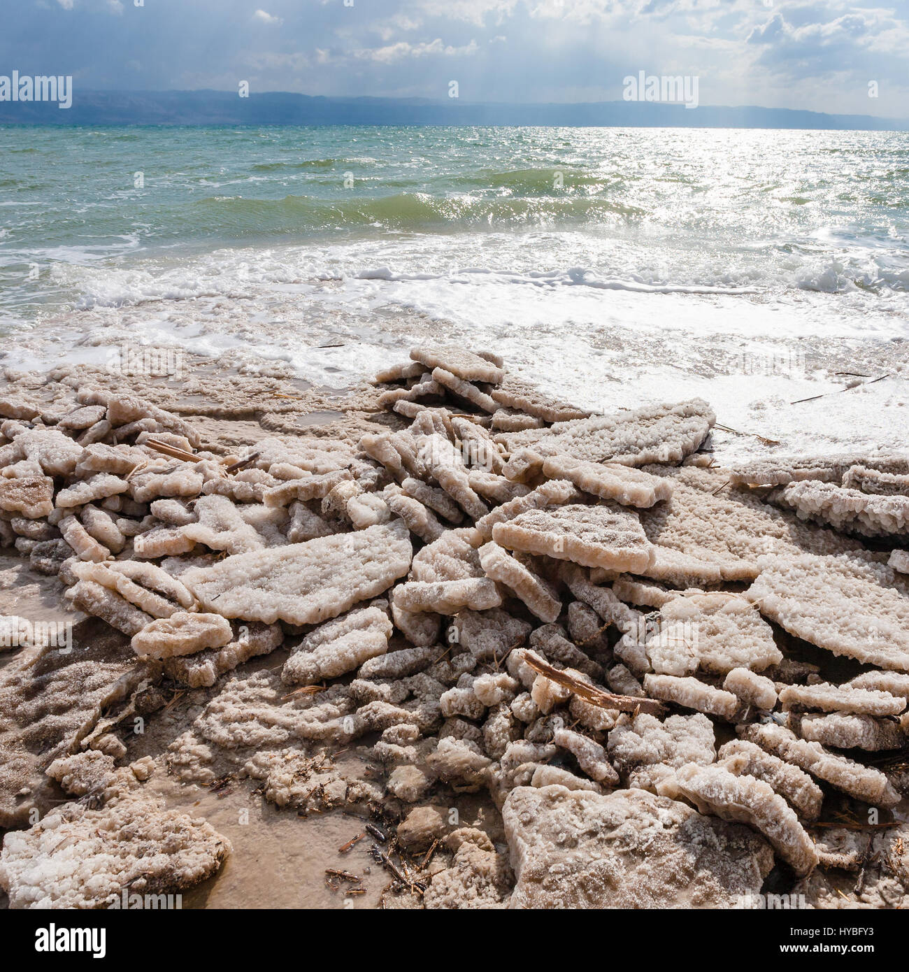 Travel to Middle East country Kingdom of Jordan - natural salt on shore of Dead Sea in winter Stock Photo