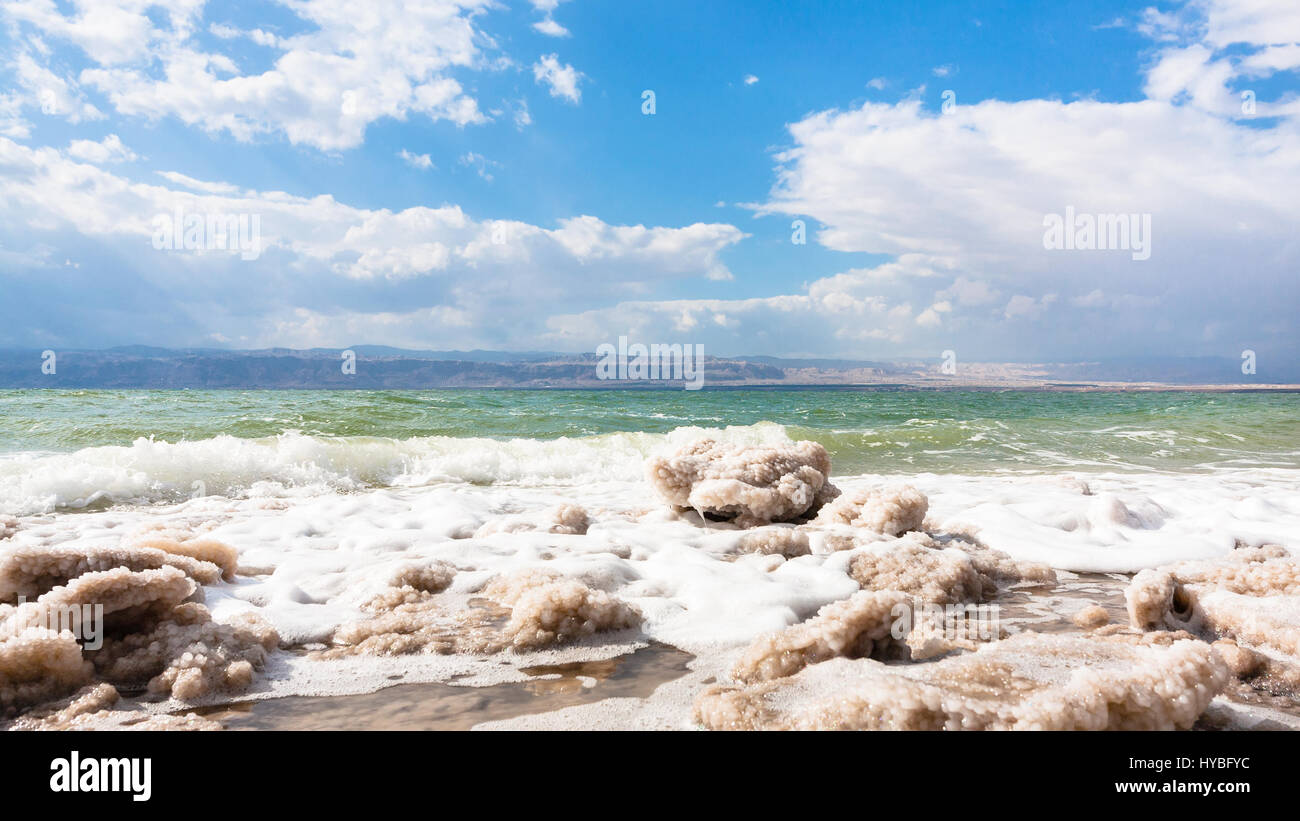 Travel to Middle East country Kingdom of Jordan - pieces of crystalline salt on surface of Dead Sea waterfront in winter Stock Photo