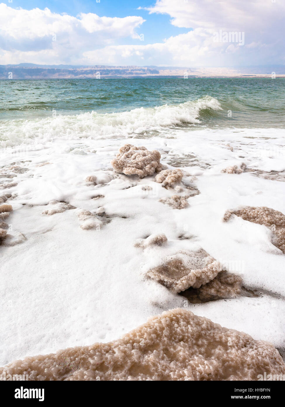 Travel to Middle East country Kingdom of Jordan - pieces of crystalline salt on shore of Dead Sea in winter Stock Photo