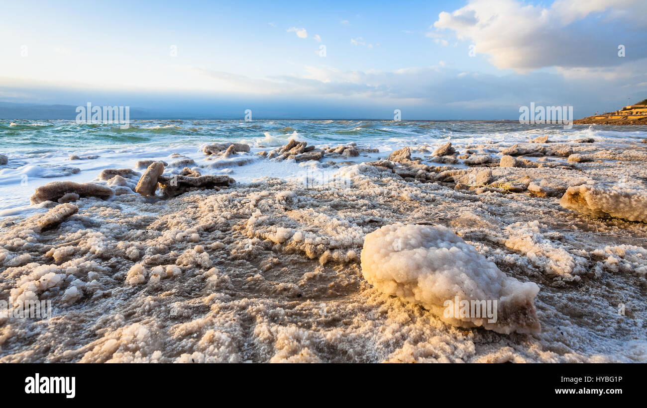 Travel to Middle East country Kingdom of Jordan - piece of salt close up on shore of Dead Sea on winter sunset Stock Photo