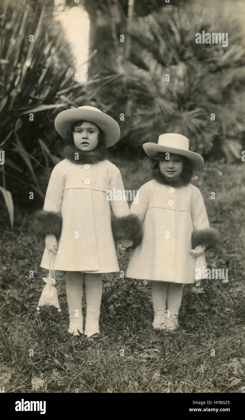 Two elegant girls dressed alike, Italy Stock Photo