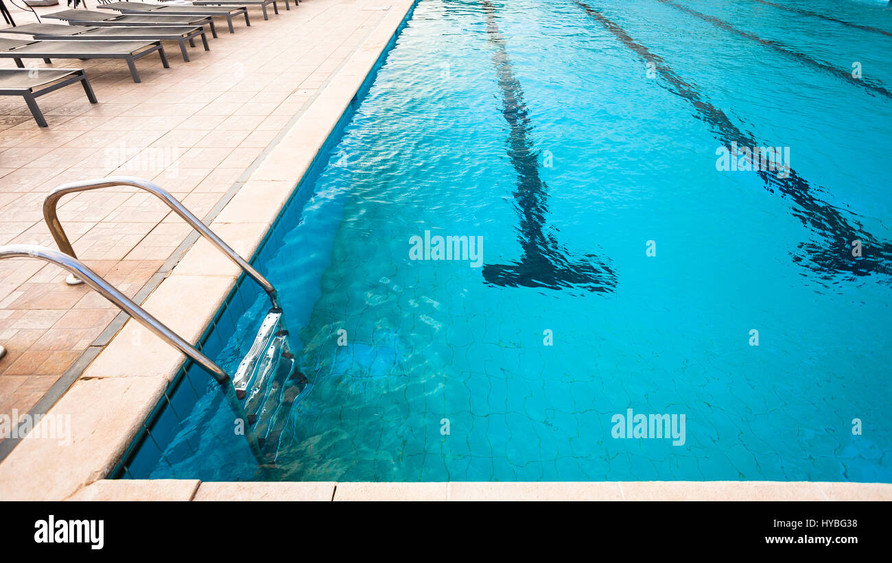 outdoor swimming pool with blue water in evening Stock Photo - Alamy