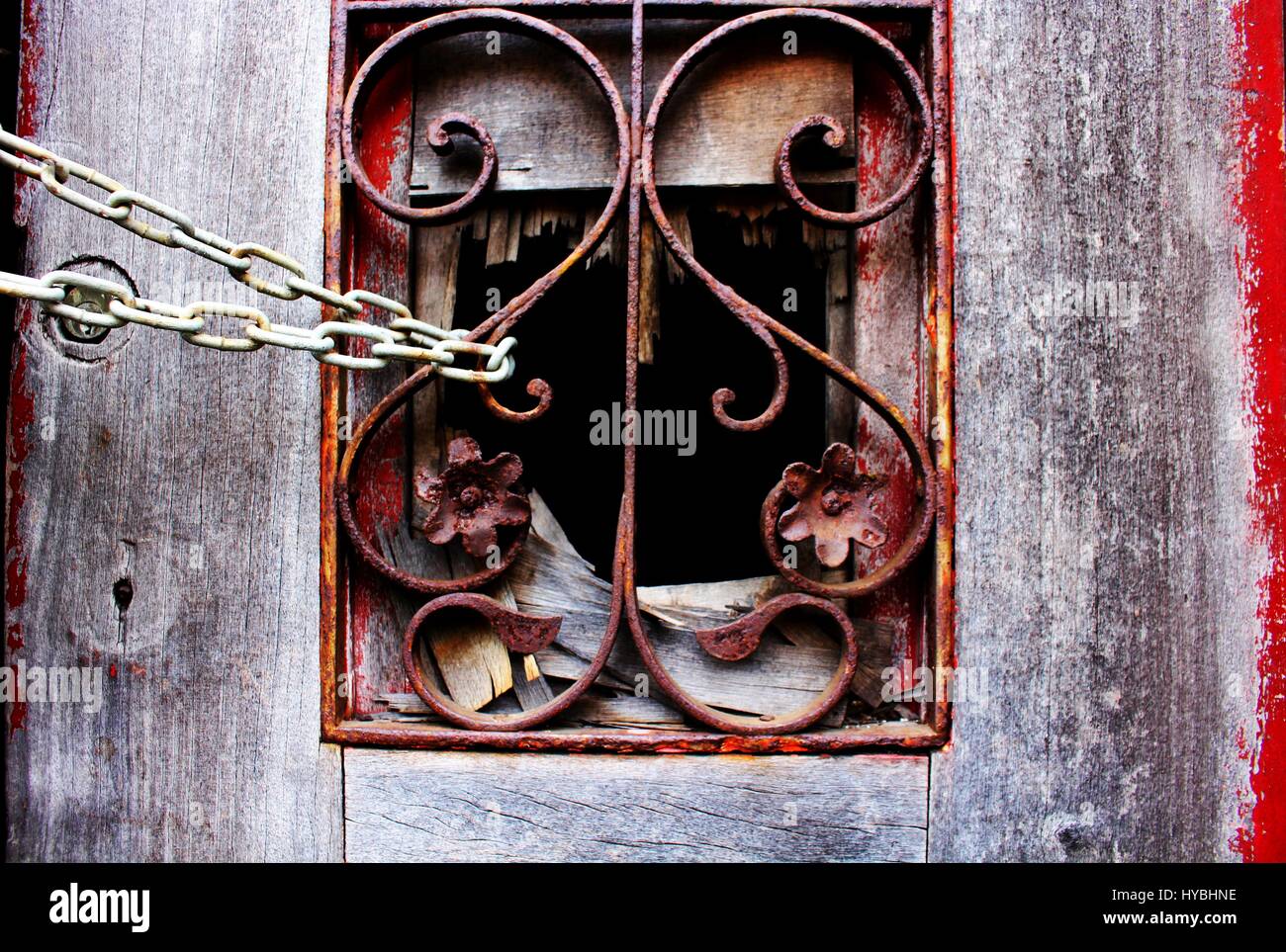 The inkless front door of an old abandoned house, in Matosinhos city, locked with a chain. Stock Photo