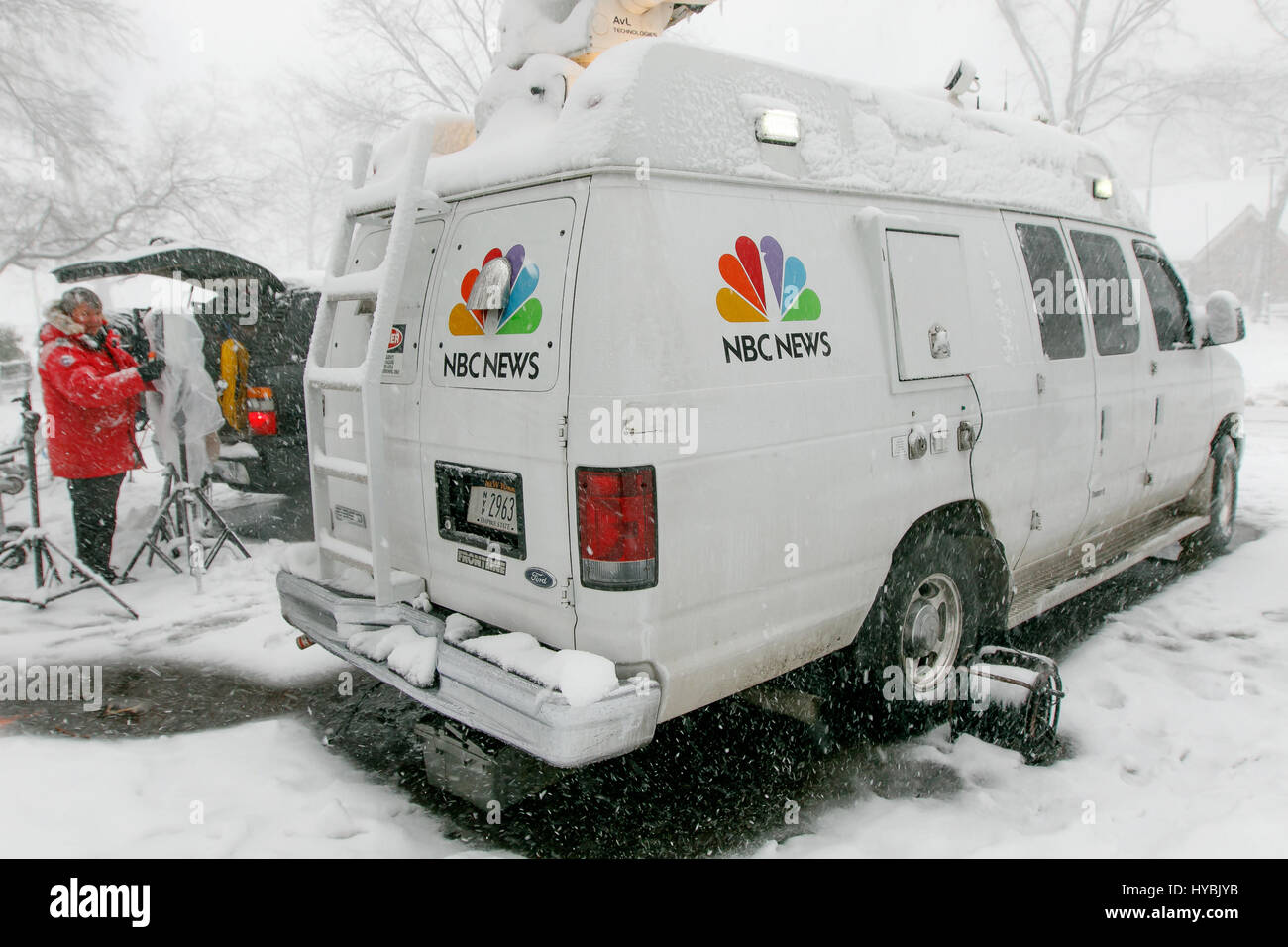 An NBC News employee is preparing broadcasting gear during a heavy snowfall in Central Park. Stock Photo