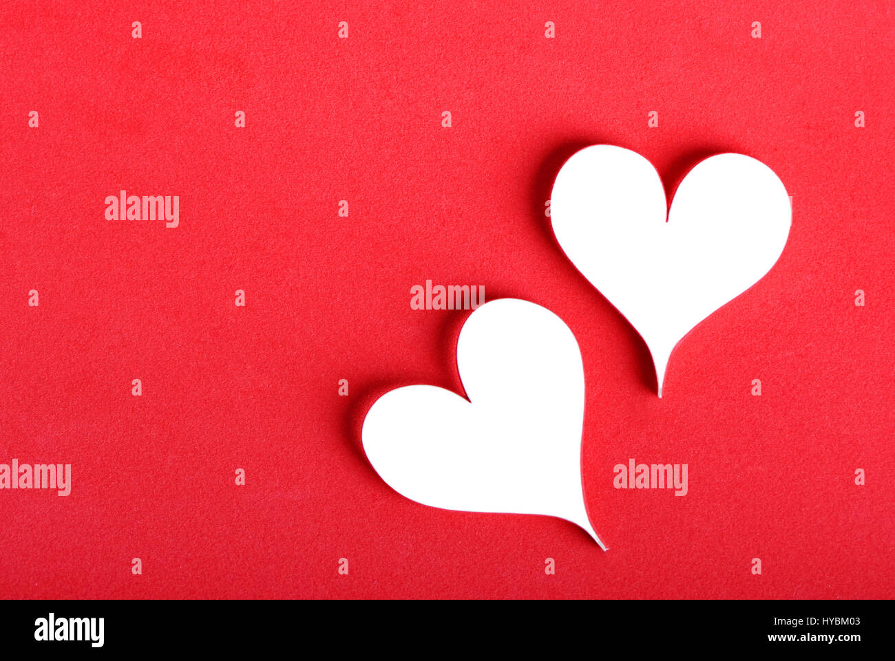 White Valentine's paper hearts on red background Stock Photo - Alamy