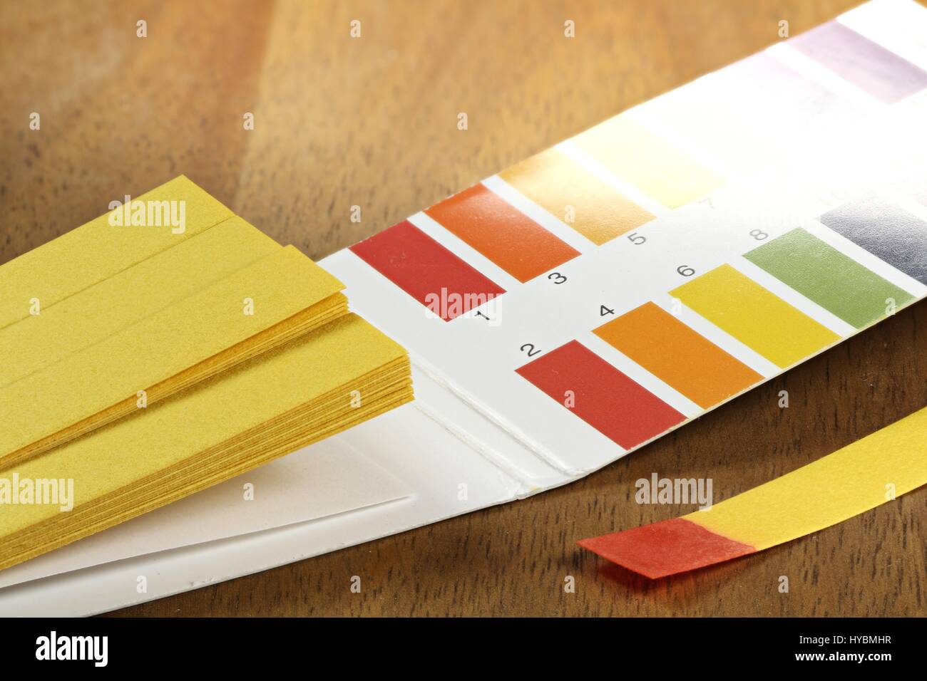 universal indicator paper with acidic testing Stock Photo