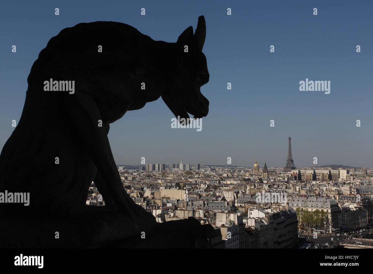 Gargoyles on Notre-Dame with a view of the Paris skyline. Stock Photo