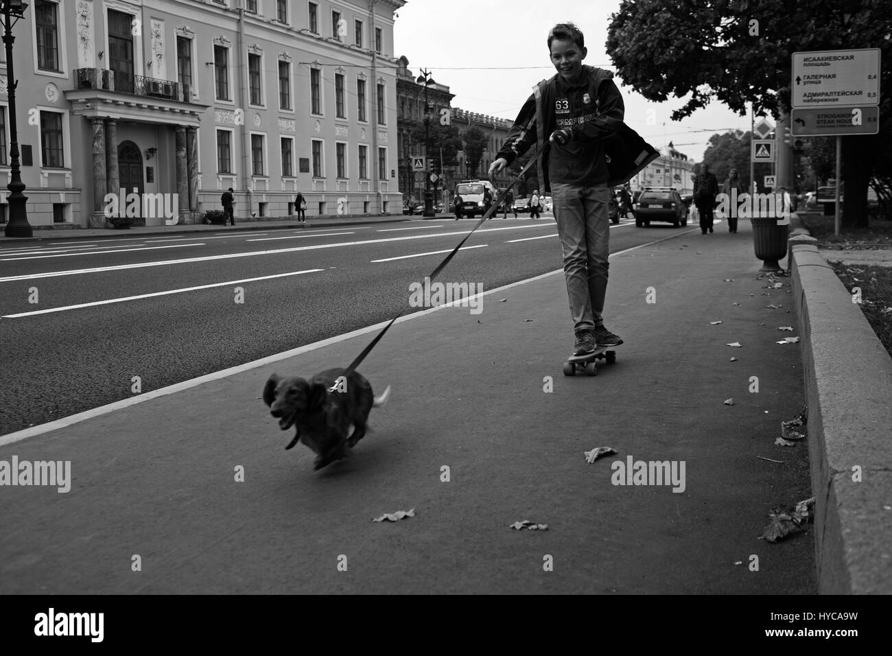 child skating with dog, St Petersburg, Russia Stock Photo