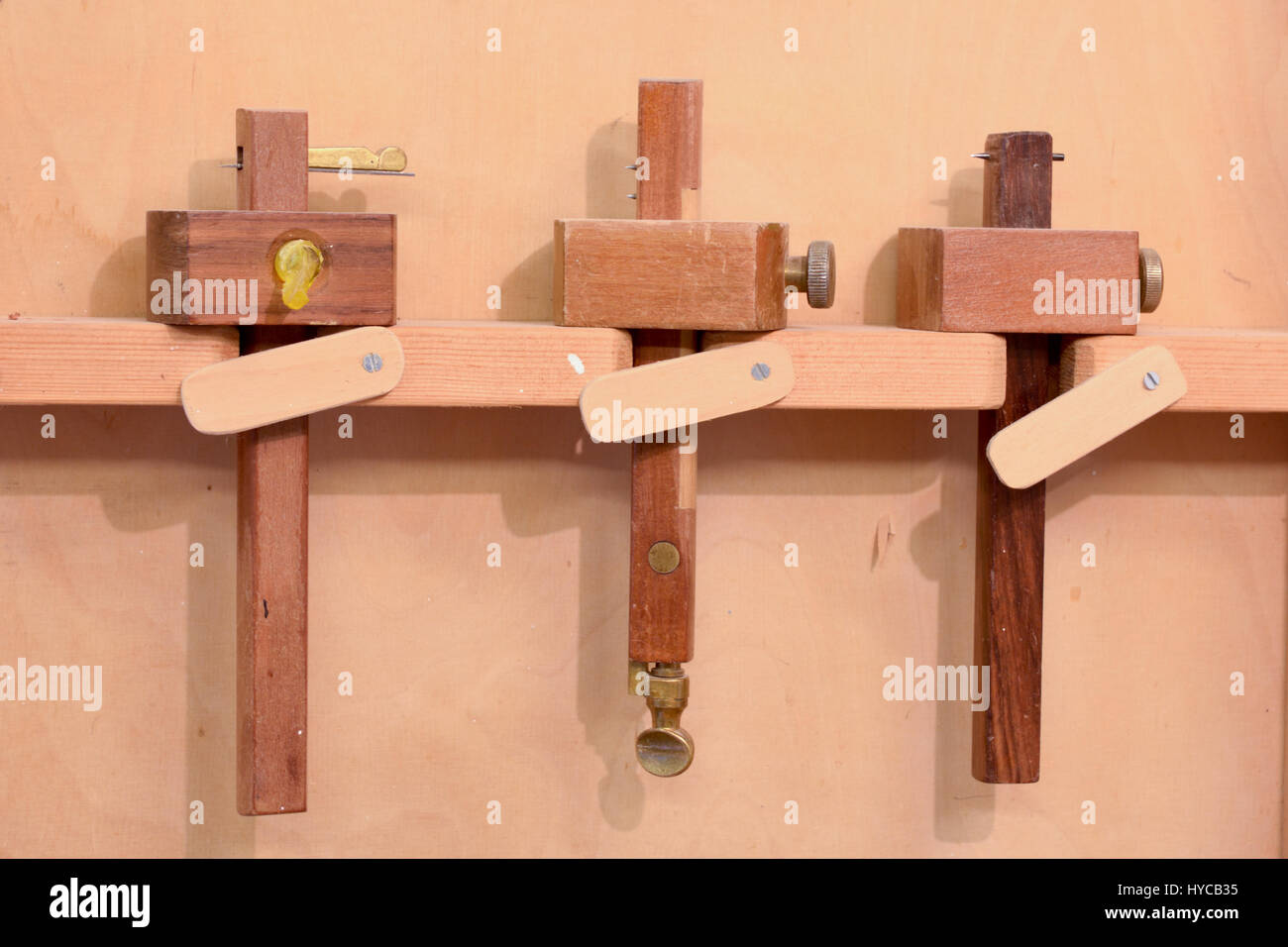 Three mortise gauges in a cupboard in a carpenters hires
