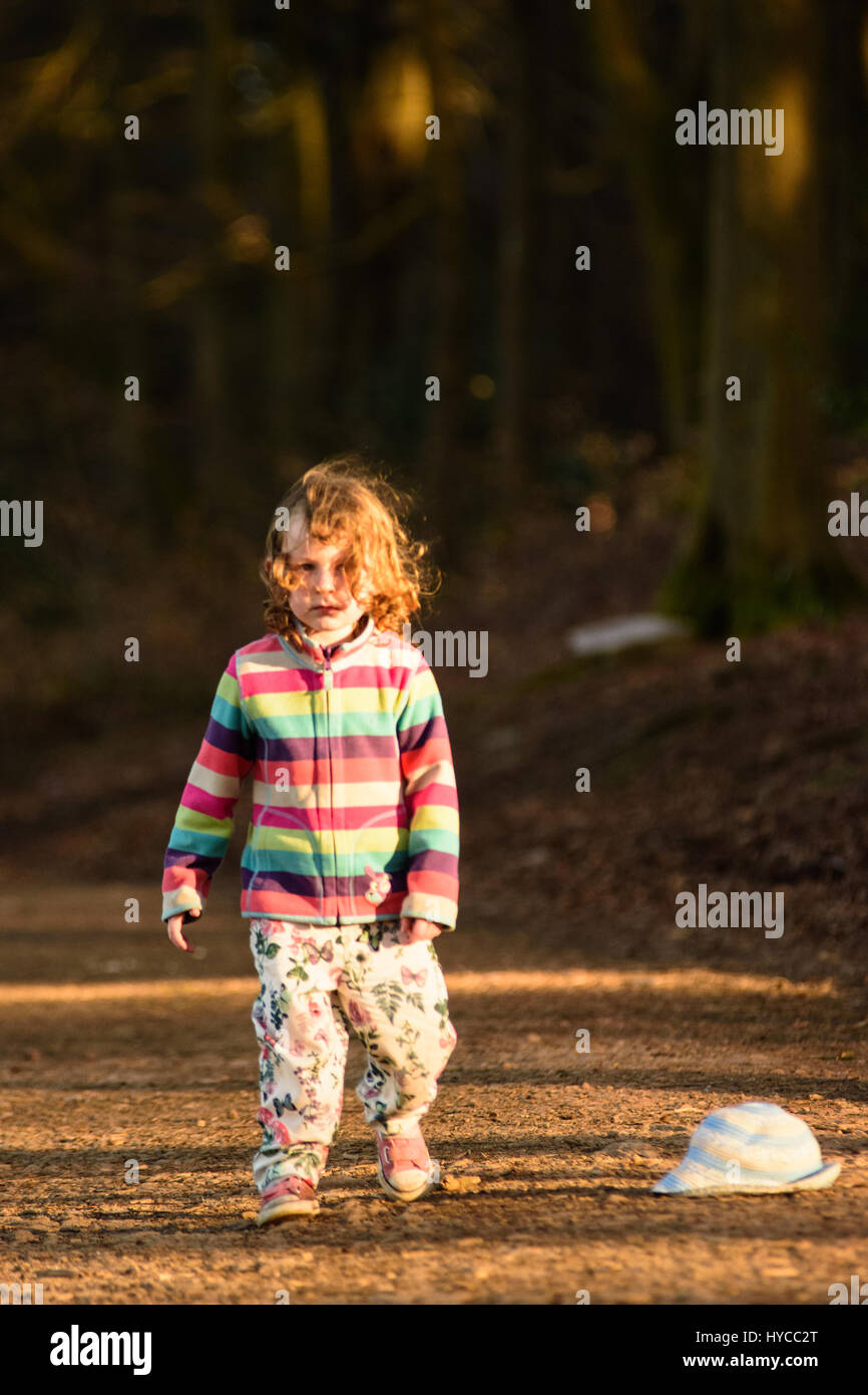 little girl playing in the woods on a family outing Stock Photo - Alamy