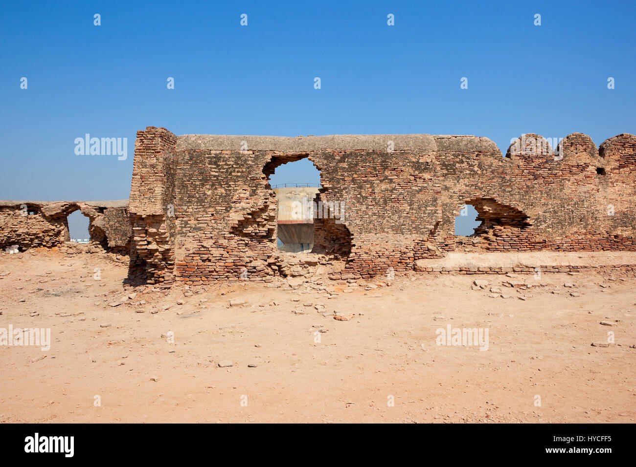 old walls in need of restoration at bhatner fort hanumangarh rajathan india with a water tower under a blue sky Stock Photo