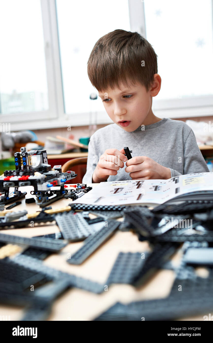 Little boy collects the children's plastic construction toys Stock Photo