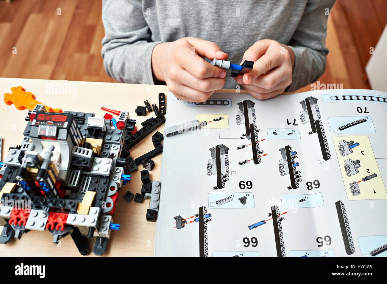 Boy collects the children's plastic construction toys Stock Photo